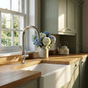 Kitchen with wooden countertop white sink and ARNO Halo chrome tap with natural light