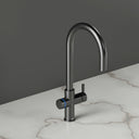 ARNO Halo brushed gunmetal boiling water tap blue LED halo ring side view on marble countertop