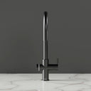 ARNO Halo 6 in 1 boiling water tap brushed gunmetal front view on marble countertop dark background standby mode