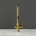 RNO Halo 6 in 1 sparkling water tap brushed gold front view with pull out spray head extended on marble countertop