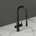 ARNO Halo matt black instant boiling water tap side view with pull out spray head on marble countertop